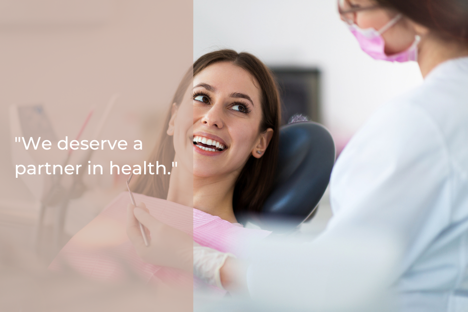 A patient sits in a dental chair smiling at a dentist wearing a mask and gloves, with text overlay reading, "We deserve a partner in health.
